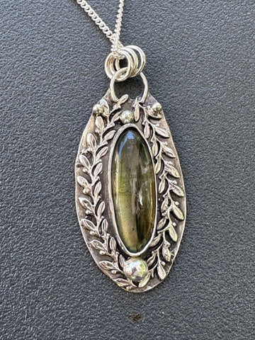 Labradorite - Surfboard Labradorite surrounded by Laurel Leaves