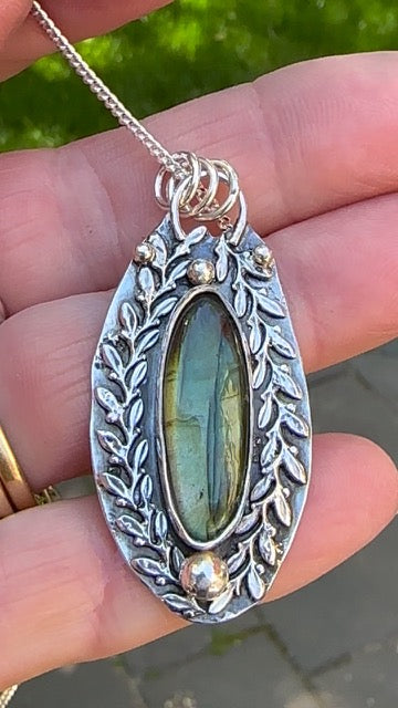 Labradorite - Surfboard Labradorite surrounded by Laurel Leaves