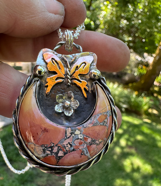 moon-shaped Maligano Jasper stone, copper butterfly, and silver flower, bordered by twisted silver wire  (1089)